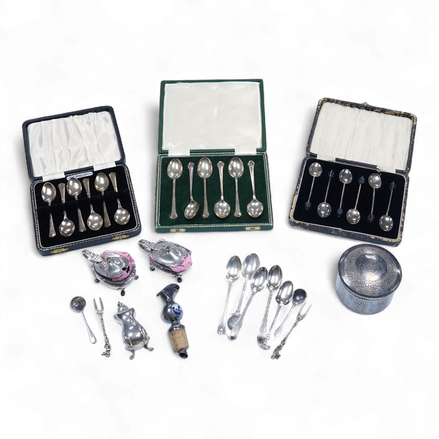 A collection of silver and white metal to include a 19th century Indian dressing table pot and cover chased with flowers, a three piece silver condiment set by Mappin and Webb with associated condiment spoon, three cased